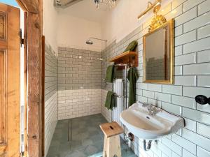 a white bathroom with a sink and a mirror at Der Pfeil - Gutshaus Bückling in Rambin +24 photos