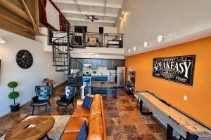 a living room with a couch and a spiral staircase at Mario Room Waterfront Downtown View Cedar Point! in Sandusky