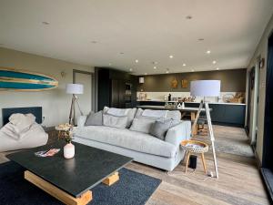 a living room with a couch and a kitchen at Uno Moor Side - 4 Bed, 2 Bath, Garden, sleeps 8 - Parking in Carbis Bay