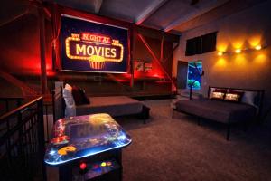 a living room with a movie theater with a video gameuminati at Mario Room Waterfront Downtown View Cedar Point! in Sandusky
