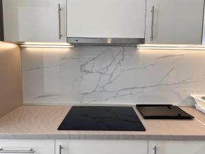 a kitchen with white marble counter tops and a sink at Villa Maja in Trebinje