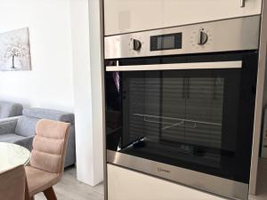 a oven in a living room with a couch at Villa Maja in Trebinje +22 photos