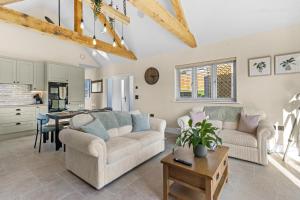 a living room with two couches and a table at Vine Cottage in Westfield