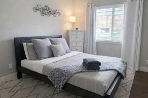 a bedroom with a bed with a backpack on it at Condo with Sauna & Fitness Center, Adjustable Base King Sized Bed in Coeur d'Alene +25 photos