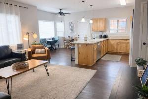 a kitchen and living room with a couch and a table at Condo with Sauna & Fitness Center, Adjustable Base King Sized Bed in Coeur d'Alene
