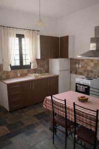 a kitchen with a table and a sink and a stove at villa Belian 3 in Argalasti