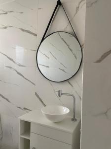 a bathroom with a round mirror on the wall at Caesars Castle - Hidro e Vista Cinematográfica na Mantiqueira in Pindamonhangaba +37 photos
