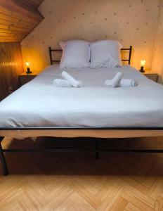 a bedroom with a bed with two towels on it at Maison Atypique 5 chambres in Le Mans +7 photos