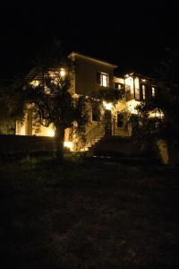 a house lit up at night with lights at villa Belian 3 in Argalasti +9 photos