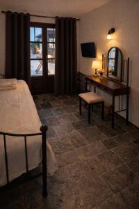a bedroom with a bed and a desk and a mirror at villa Belian 3 in Argalasti