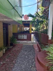 a house with a walkway in front of it at Ofiuras Hostal in Colón