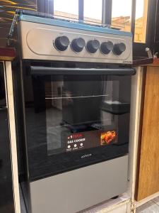 an oven with its door open in a kitchen at Studio standing in Dakar
