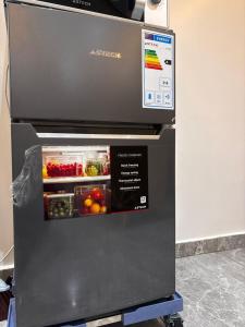 an open refrigerator with fruit and vegetables in it at Studio standing in Dakar
