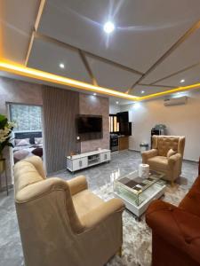 a living room with couches and a tv and a couch at Studio standing in Dakar +14 photos