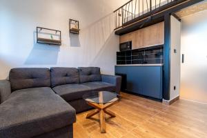 a living room with a couch and a table at Pink bird apartments and FREE PARKING in Virpazar