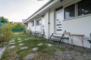 a group of chairs sitting outside of a house at Pink bird apartments and FREE PARKING in Virpazar +6 photos