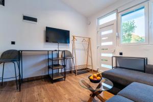 a living room with a couch and a table at Pink bird apartments and FREE PARKING in Virpazar