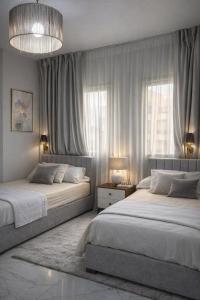 a bedroom with two beds and a large window at Arian North Coast Chalet Santorini Resort El Alamein in El Alamein
