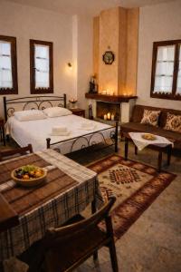 a bedroom with a bed and a table and a couch at Villa Belian 1 in Argalasti