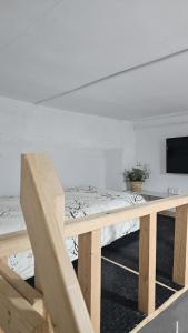 a room with a bed and a table with a television at Habitacion en casa de familia "ValenciaBonita" in Valencia