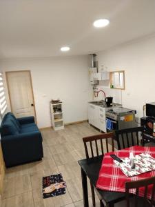 a kitchen and a living room with a table and chairs at Cabañas Haru Puerto Natales in Puerto Natales +23 photos
