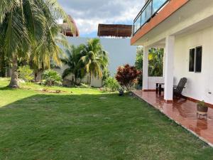 a backyard of a house with a lawn at GalHaus in Bacalar
