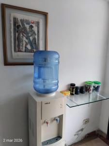 a blue water container on top of a refrigerator at Hotel Real, Villa Garzón in Villagarzón