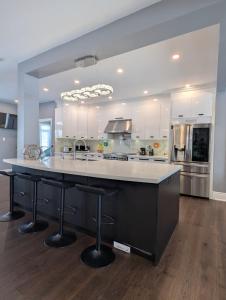 a large kitchen with a large island in the middle at Picturesque Luxury Waterside Villa in Niagara Falls