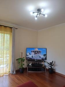 a living room with a flat screen tv on a wall at Paradise Valley Ponta do Sol in Ponta do Sol