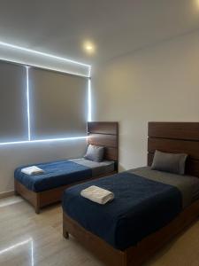 a bedroom with two beds and a window at Departamento en Yatay Towers in Hércules