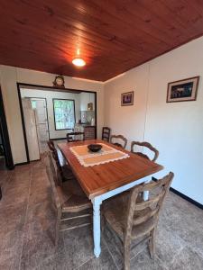 a dining room with a wooden table and chairs at Carpe diem CyC in Chascomús