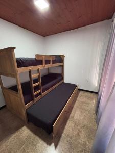 a bedroom with two bunk beds in a room at Carpe diem CyC in Chascomús
