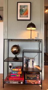 a book shelf with books and a lamp on top at Baumhausfeeling im Wald nahe der Loreley in Bogel