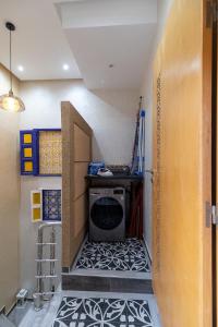 a laundry room with a washer and a tile floor at FIFI maison in Ouarzazate