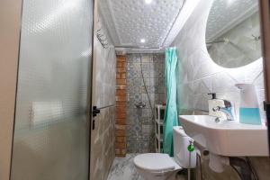 a bathroom with a shower and a toilet and a sink at FIFI maison in Ouarzazate +7 photos