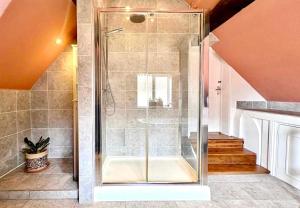 a shower with a glass door in a bathroom at The Corner House, Shipston-on-Stour in Shipston-on-Stour