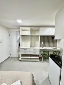 a living room with white cabinets and a kitchen at G5 Beach Flat Intermares 304 in Cabedelo