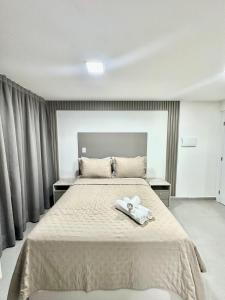 a bedroom with a bed with two white towels on it at G5 Beach Flat Intermares 304 in Cabedelo