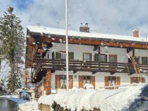 a house in the snow with snow covered at Wildstein - Ferienwohnungen in Bayrischzell