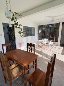 a dining room with a wooden table and chairs at GalHaus in Bacalar +47 photos