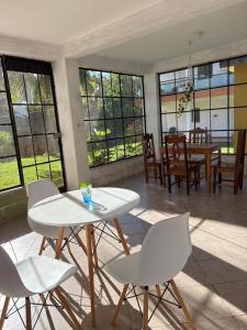 a room with a table and chairs and a dining room at GalHaus in Bacalar