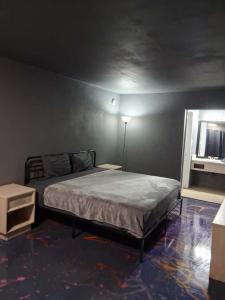 a bedroom with a bed in a room with a window at King Bed Hotel Room 255 in Jackson
