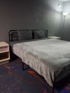 a bedroom with a bed and a lamp and a table at King Bed Hotel Room 255 in Jackson