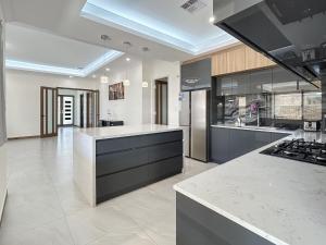 a large kitchen with a large island in the middle at Spacious 4 bed home with open plan living in Perth
