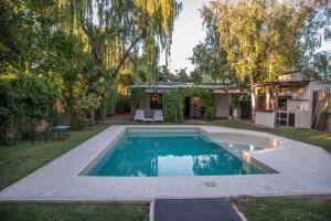 a swimming pool in a yard with a gazebo at Encantadora casa de campo in Ciudad Lujan de Cuyo