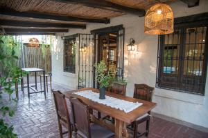 a wooden table and chairs on a patio at Encantadora casa de campo in Ciudad Lujan de Cuyo