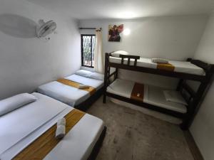 a room with three bunk beds and a window at Gaia Rodadero in Santa Marta