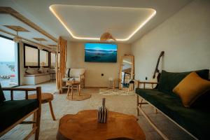 a living room with a couch and a table at Surf Lodge Tamraght in Tamraght Ouzdar