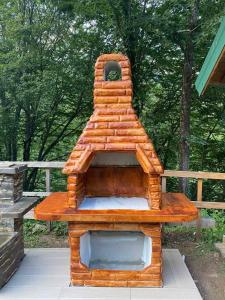 a wooden dog house sitting on a deck at Camp Budečevica in Žabljak +2 photos