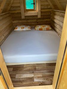 an inside view of a bed in a wooden cabin at Camp Budečevica in Žabljak